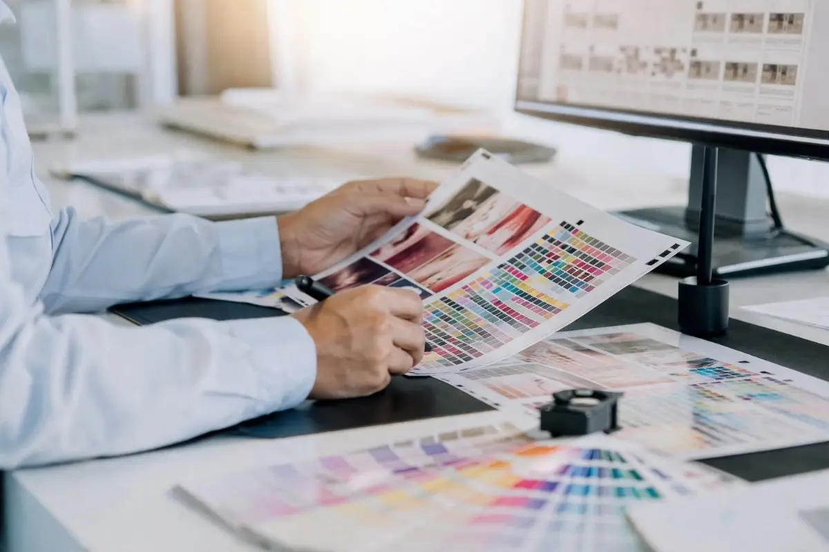 Prepress experts checking a color proof on press